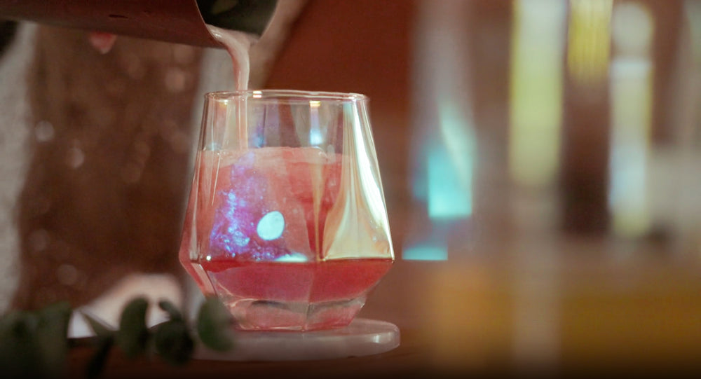 Bartender building an Altar Native herbal cocktail over ice