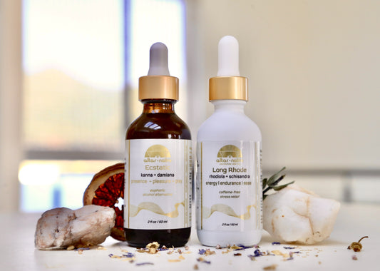 bottles of luxury herbal tincture blends of with gold caps on a  white counter with crystals and garnish 