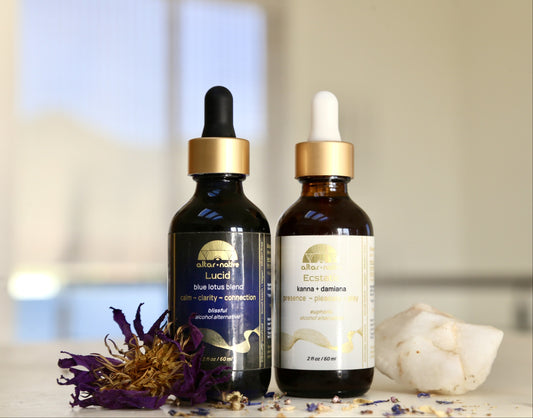 Two bottles of herbal alcohol alternatives on a blurred background with flowers and crystals